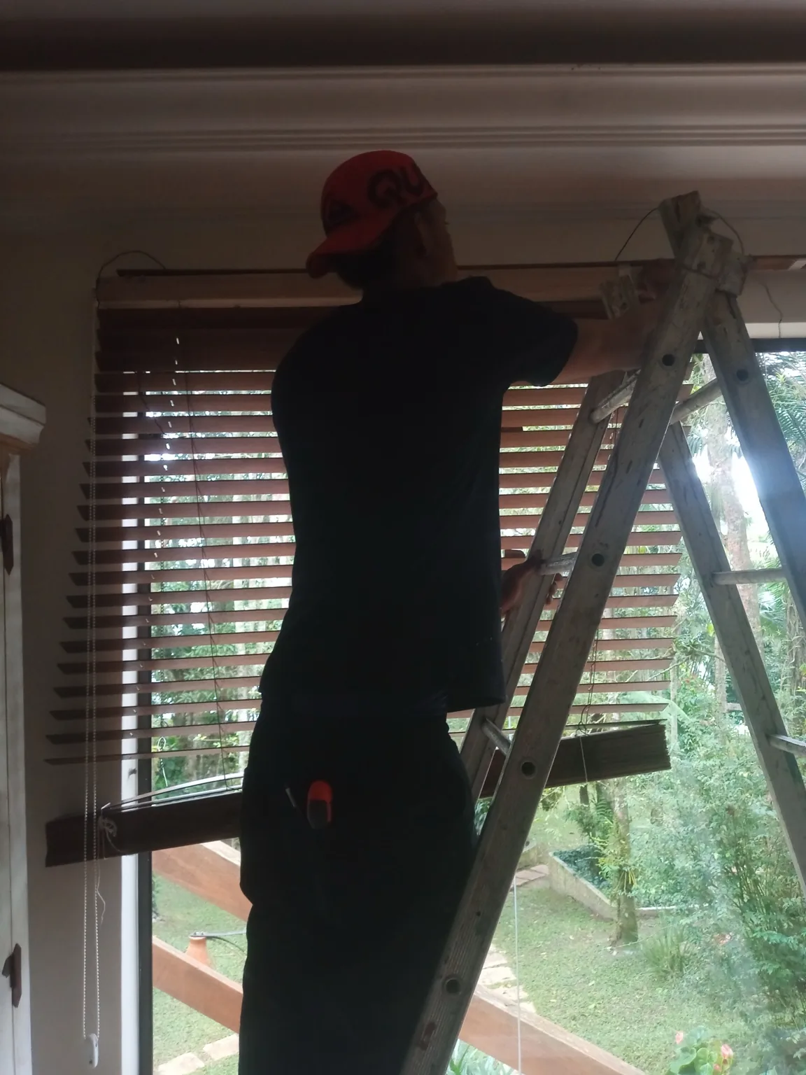 Técnico realizando manutenção em persiana horizontal